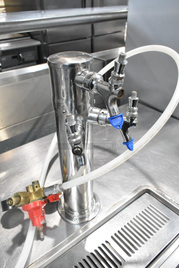Beverage Air DD48Y-1-B kegerator tower with three taps, chrome finish, connected hoses, shown on stainless steel surface.