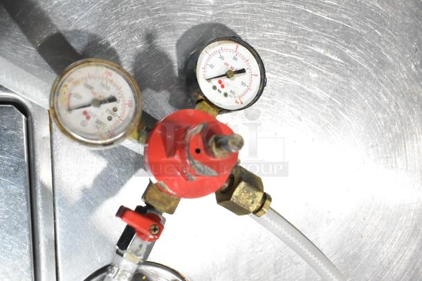 "Close-up of pressure gauges and red regulator on Beverage Air DD48Y-1-B kegerator, showing hose connections. Model detail."