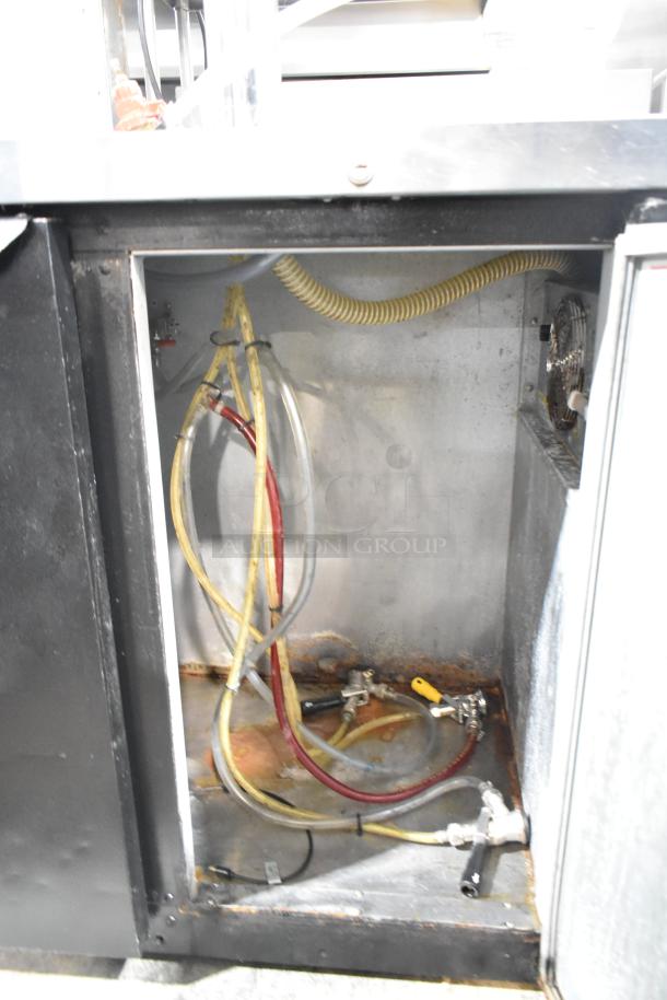 Beverage Air DD48Y-1-B kegerator interior showing hoses and fittings; condition appears used with signs of wear.