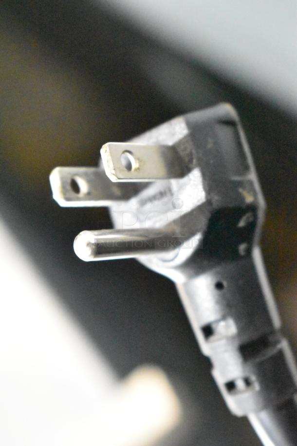 Close-up of a power plug for an Everest EMGR33 Commercial 2 Door Reach In Cooler Merchandiser, 115V, 1 Phase.