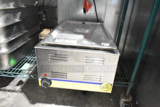 Qualite RDFW-1200NP commercial countertop food warmer, 120 volts, fair condition, visible branding label, and dial control.