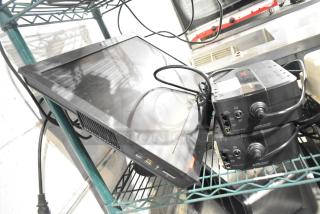 Three-item lot: two APC uninterruptible power supplies and a ThinkCentre monitor. Used, visible cables, positioned on a shelf.