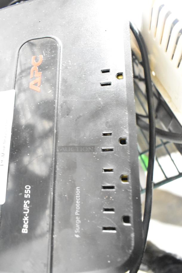 APC Back-UPS 550 uninterruptible power supply with surge protection, visible wear, includes cables.