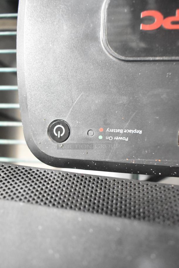 Close-up of APC Uninterruptible Power Supply showing power button and replace battery indicator. Slight wear visible.