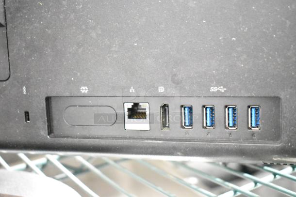 Close-up of a ThinkCentre monitor showing ports, including Ethernet, DisplayPort, and USB. Slight dust present.