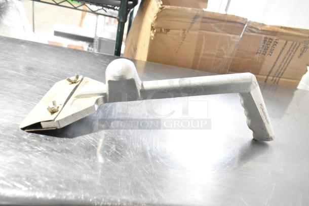 Metal grill scraper with ergonomic handle and dual brass screws; sturdy construction, used condition.