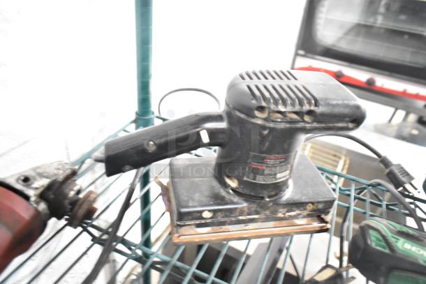 Various tools including Craftsman finishing sander, Hitachi impact driver, and Black and Decker drill, in used condition.