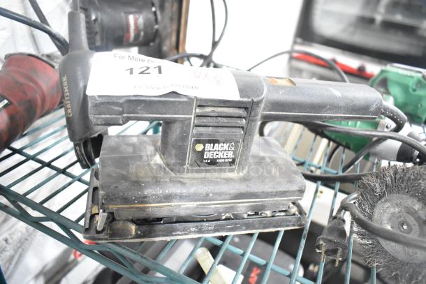 Collection of tools including Black and Decker sander, Craftsman finishing sander, and Hitachi cordless impact driver, used condition.