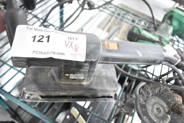 Eight power tools on shelf: Black & Decker sander, Hitachi impact driver, Craftsman sander, Skilsaw, drill. Item tag "121 QTY VX8".