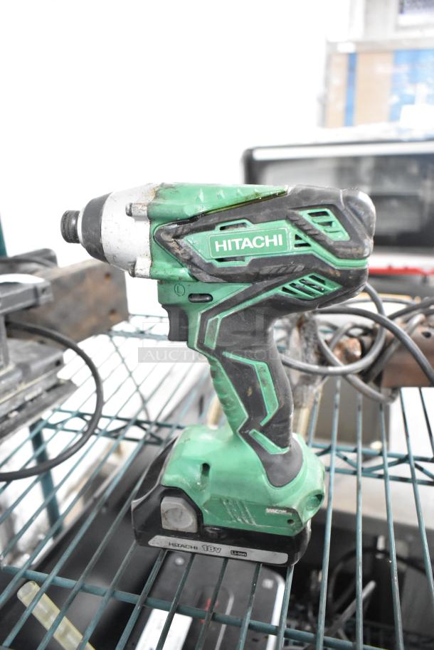 Hitachi cordless impact driver, 18V, Li-ion. Visible wear. Part of a lot including an angle grinder, sanders, drill, and saw.