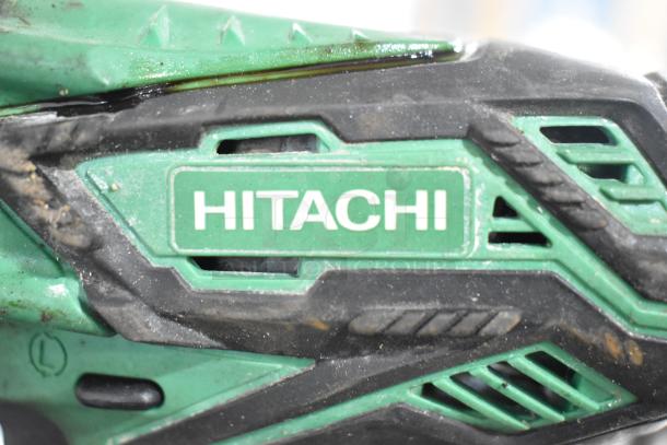 Hitachi cordless impact driver, green and black, moderate wear, visible brand logo, part of 8-item tool auction set.