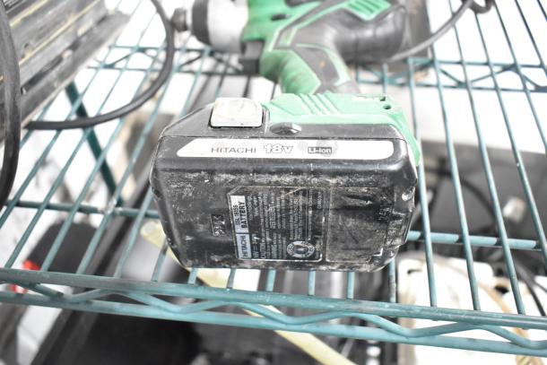Hitachi 18V Li-Ion cordless impact driver, visible battery labels. Used condition on wire shelf.