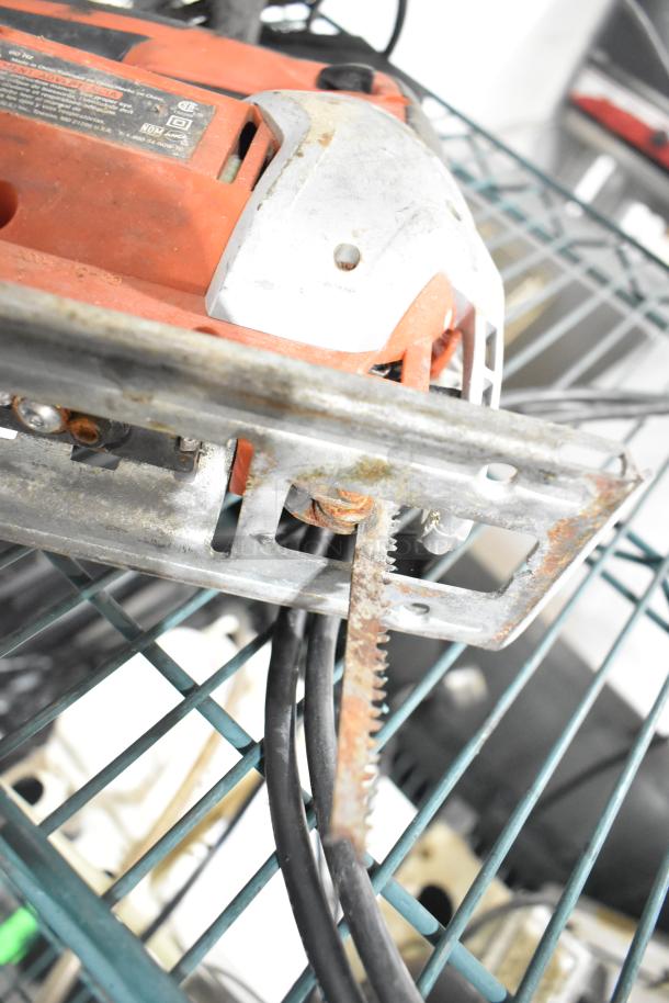 8 various tools, including an angle grinder and saw, on a shelf. Some rust visible, indicating used condition.