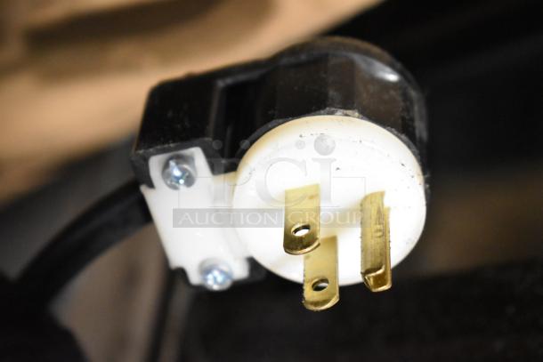 Close-up of a power plug for a Marc commercial floor style deli display case, 115 volts, 1 phase.