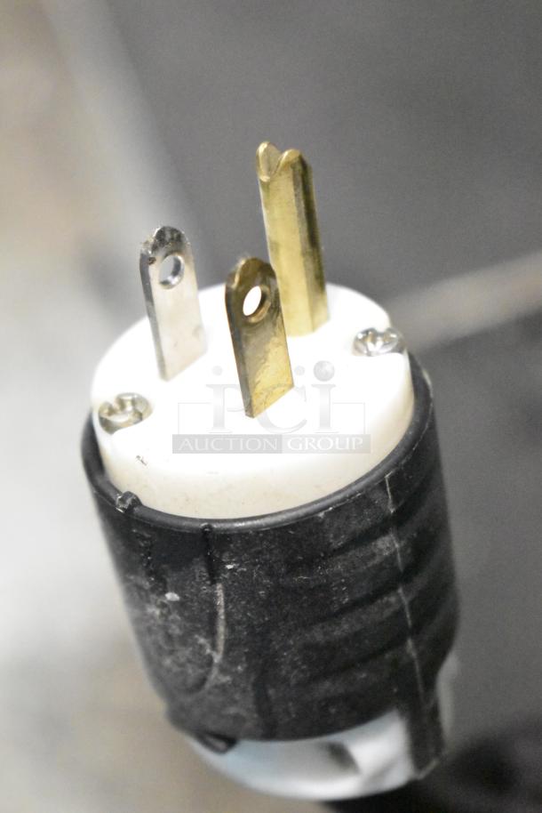 Close-up of a power plug for Electrolux Air-o-convect Touchline 9F92225200 convection oven, showing three prongs and black casing.