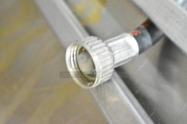 Close-up of a metal fitting on the Electrolux Air-o-convect Touchline oven, model 9F92225200.