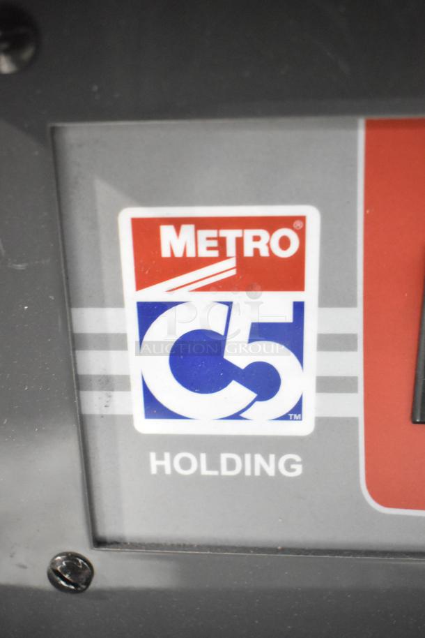 Metro C5 3 Series insulated hot holding cabinet label, showing logo and model info; glass missing, commercial casters.