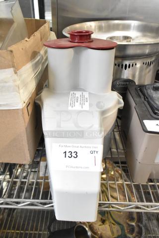 Brand new gray poly continuous feed head attachment for food processor, minor dents, auction tag "133" visible.