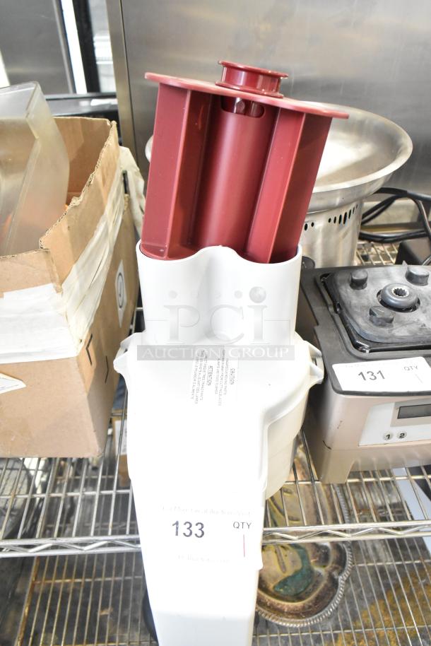 Brand new gray poly continuous feed head attachment for food processor, minor scratches, tags indicate auction item 133.