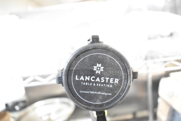 Brand new Lancaster Table & Seating stanchion with minor scratches and dents, logo visible, ideal for crowd management.