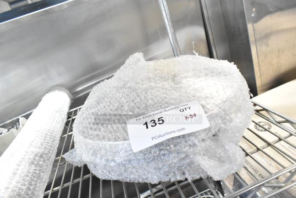 Brand new Lancaster Table & Seating stanchion in bubble wrap, tagged with "135 QTY x3," labeled for auction.