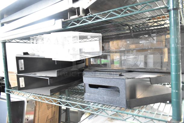Seven assorted items, including a clear lid dispenser, on metal shelving. Black organizer trays visible, various conditions.