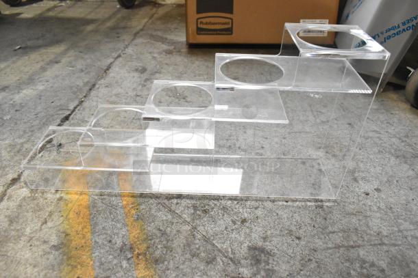 Clear acrylic stepped lid dispenser with multiple compartments, in good condition, suitable for organizing lids.