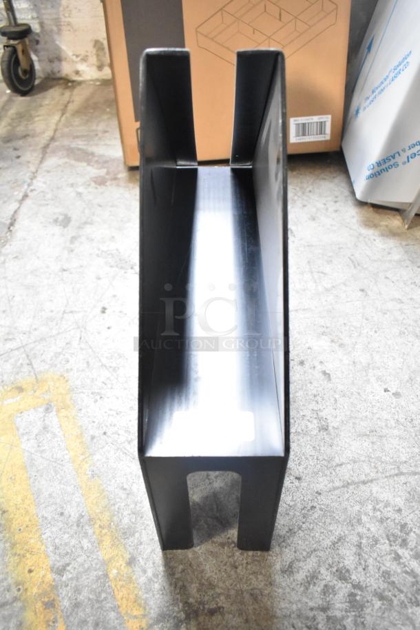 Black plastic lid dispenser in good condition, part of a seven-item auction set. Ideal for organizational use.