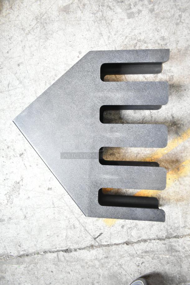 Black lid dispenser with five slots, textured finish, and a triangular design. Used condition, suitable for various lids.