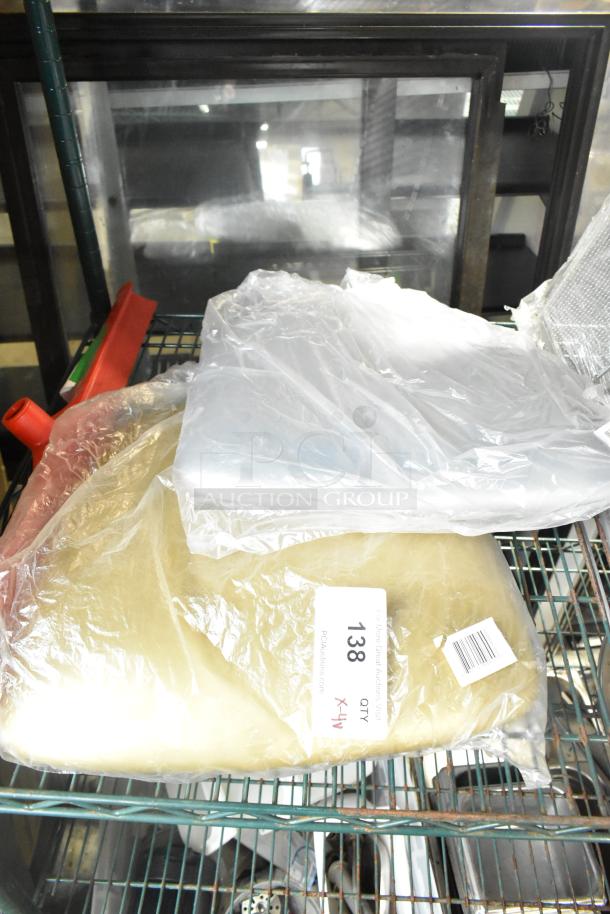 Four new Carlisle 3656805 Sparta 24" red rubber squeegees, plastic frame. Items on rack, scratch and dent. Auction tag visible.