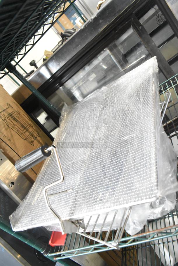 Four brand new Carlisle Sparta 24" red rubber squeegees with plastic frames, scratch and dent condition, on shelves.