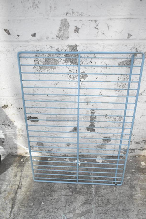 Blue metal rack in used condition, part of a mixed auction lot including various metal pieces.