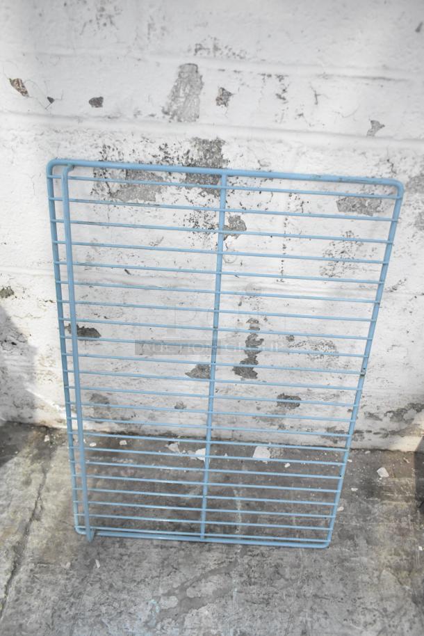 Blue metal rack panel against a textured wall. Good condition with minimal wear. Part of a diverse auction tier lot.