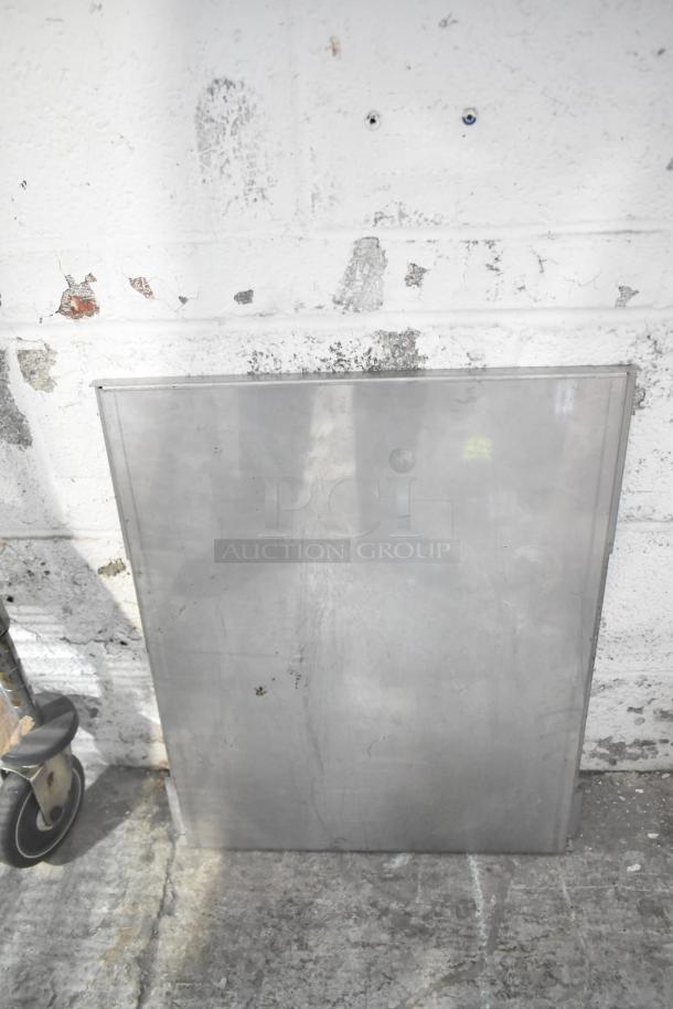 Metal sheet leaning against a worn wall, part of ALL ONE MONEY! tier lot with various items including blue poly rack.