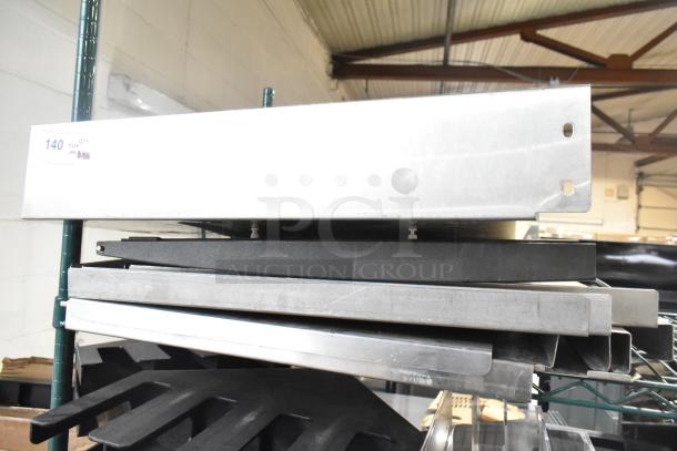 Alt text: "Auction lot featuring stacked metal pieces and blue poly rack on a shelf, labeled '140 QTY Tier Lot'."