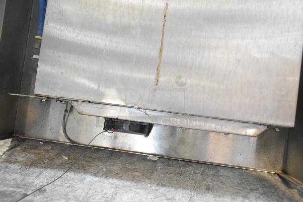 Metal piece with attached cable in used condition, part of ALL ONE MONEY! tier lot. Includes various metal items and blue poly rack.