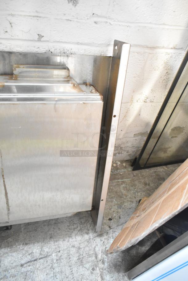 Auction lot of various metal pieces, including a silver metal panel and frame. Slight wear indicated. Includes blue poly rack.