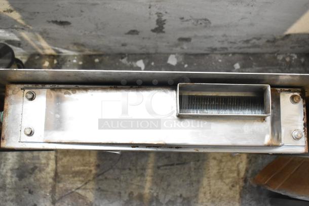 Metal piece with mounting bolts and vent-like feature from the ALL ONE MONEY tier lot, showing signs of wear.