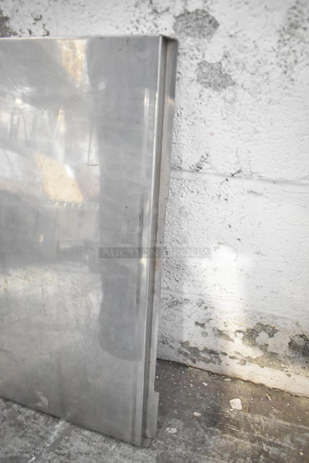 Alt Text:  
Metal panel leaning against a textured wall, part of a tiered auction lot. Condition appears used with visible scuffs.