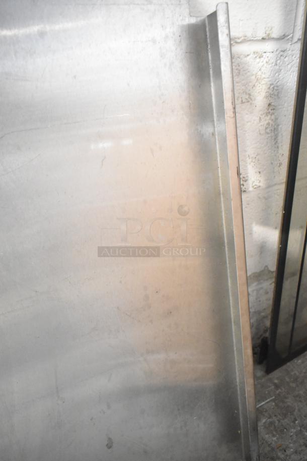 Various metal pieces stacked, featuring a blue poly rack. Items show minor wear, suitable for industrial or DIY projects.