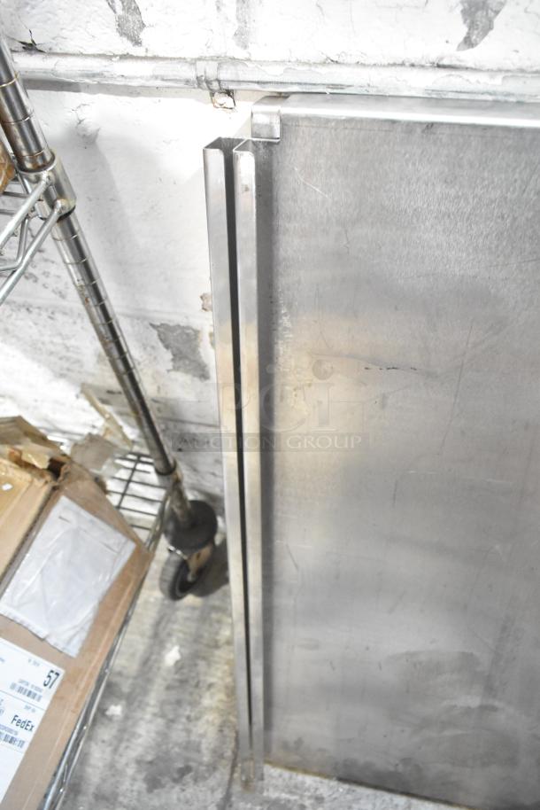 Metal pieces leaning against a wall, part of a tier lot including a blue poly rack. Items show wear, suitable for various uses.