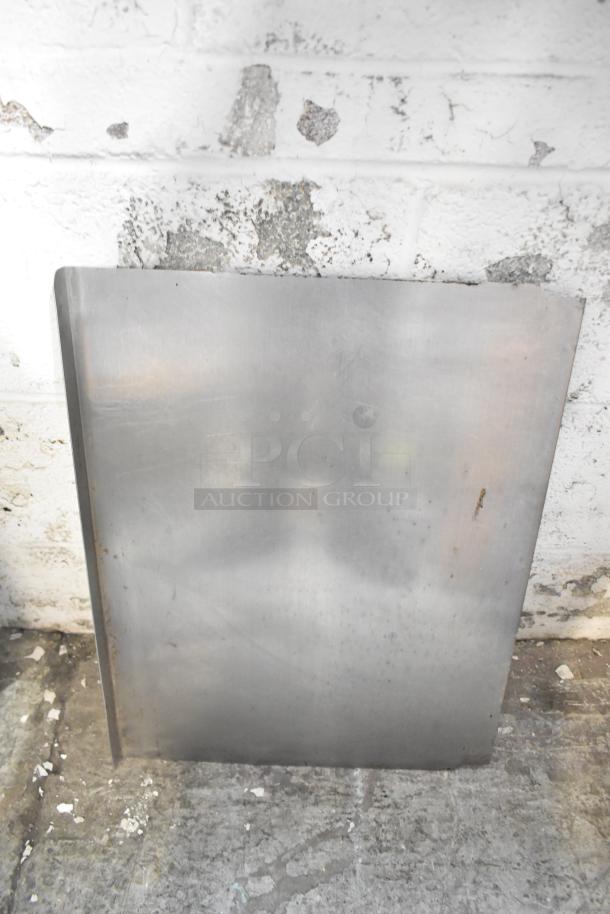 Metal panel from ALL ONE MONEY! lot, slightly worn, against a textured wall, part of a mixed-item auction collection.