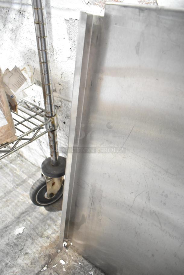 Metal pieces and shelving on caster wheel. Includes blue poly rack. Used condition, scratches visible.