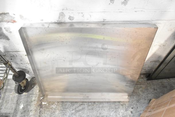 Metal panel with a reflective surface and slight patina, part of a mixed item auction lot.