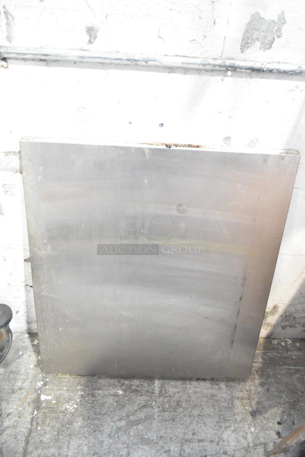 Metal sheet panel leaning against wall, with visible wear and minor surface marks, part of a mixed item auction lot.