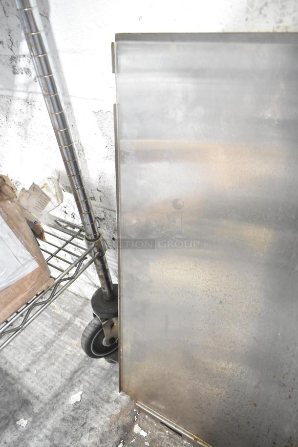 Cleaning supplies on a chrome shelf with a metal sheet and caster wheels, part of the ALL ONE MONEY! auction lot.