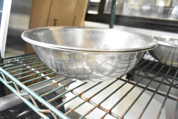 Stainless steel bowl on metal shelf, part of a set of 25 various metal bowls, shown polished and in good condition.