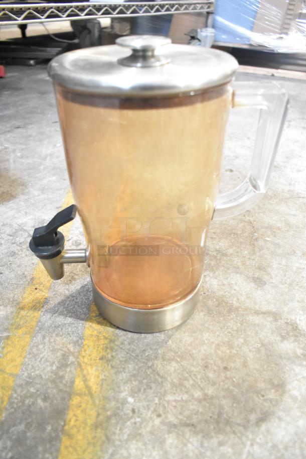 Translucent beverage dispenser with metal lid and base, featuring a side spout for easy pouring; condition appears gently used.