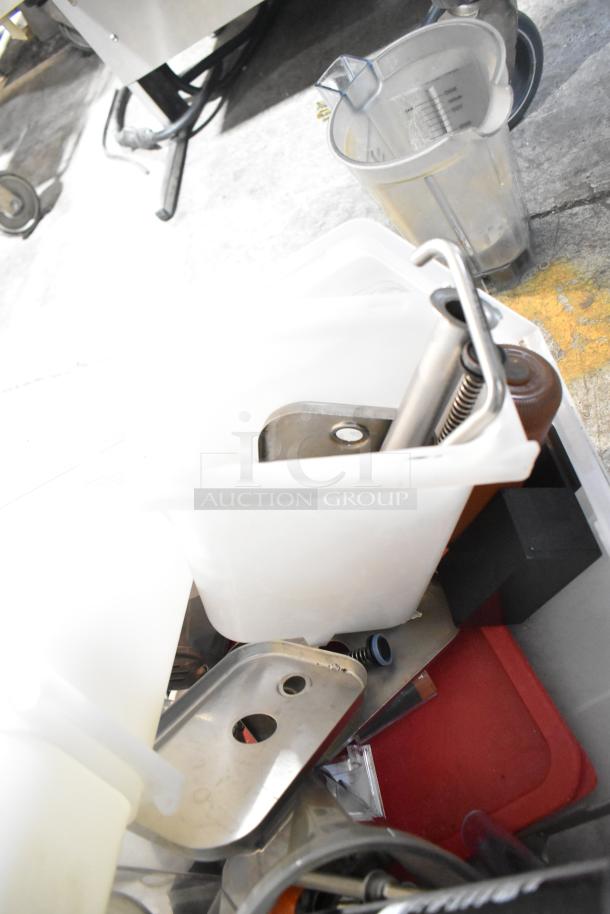 Assorted item lot including plastic bins, metal trays, and a clear beverage dispenser. Some signs of wear visible.