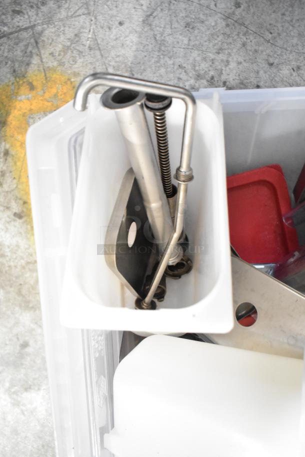 Tier lot with drop-in bins, metal fixtures, and plastic components in used condition. Includes beverage dispenser parts.